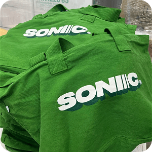 Sonic Bag Custom screen printed green tote bags with multicolored Sonic logo for merch drop