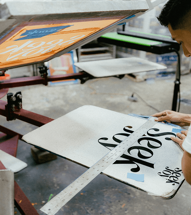 Our team screen printing custom T-shirts at our Philadelphia shop.